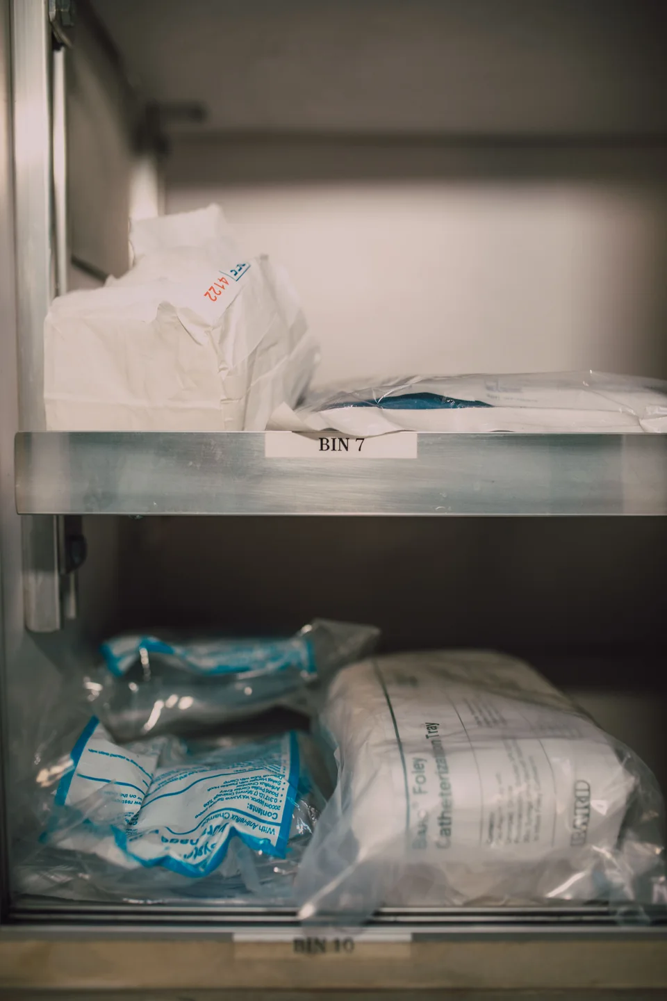 Organized medical supplies in labeled storage bins