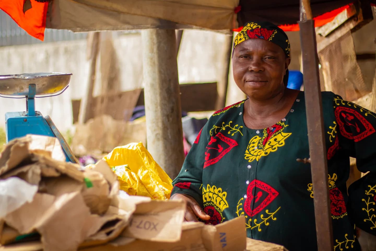A market vendor standing beside her stall