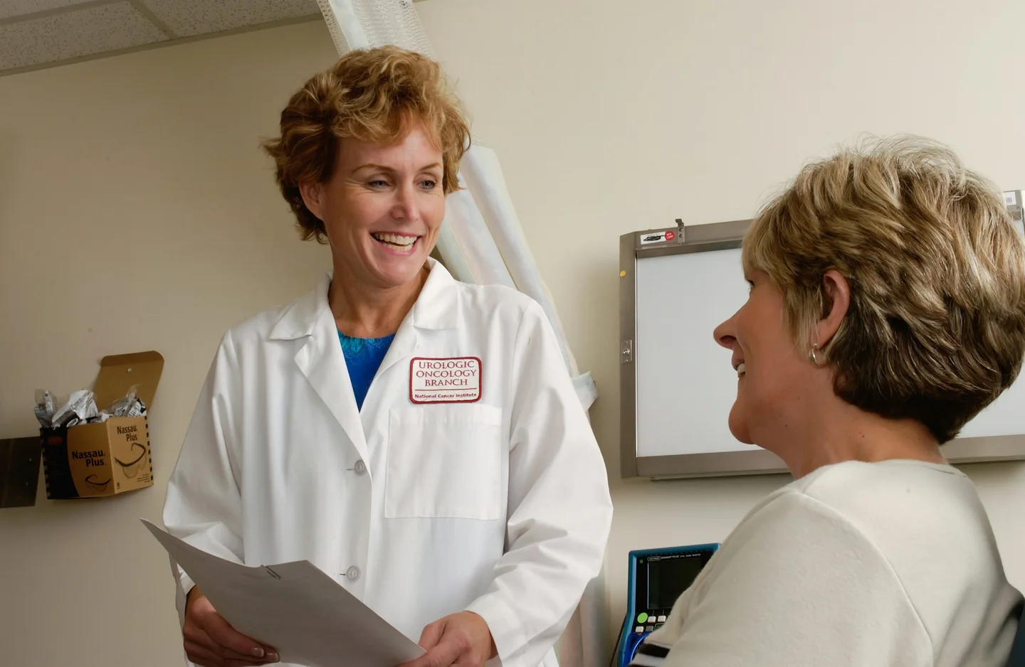 A clinician talking with a patient in a consultation room