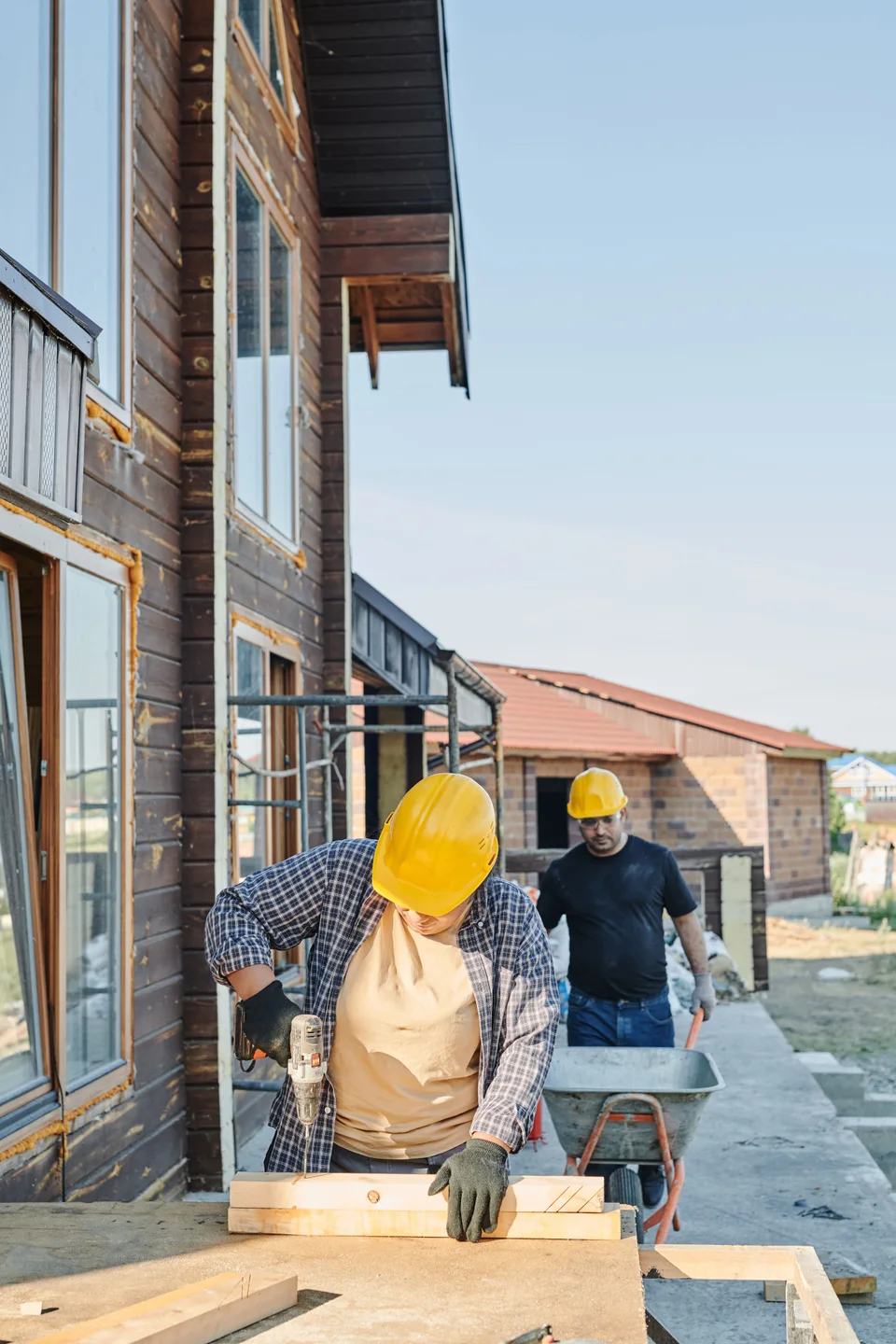 Builders working on the timber frame of a home